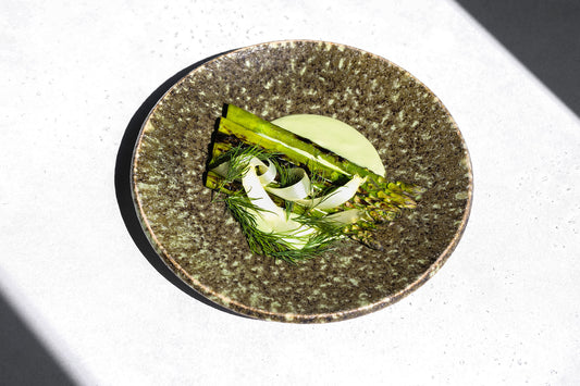 Tofu matcha sauce accompanying spears of asparagus, garnished with sprigs of fennel.