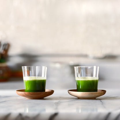 2 sets of Matcha Shot Glasses and Wooden Saucers, side-by-side, full of bright green matcha shots.