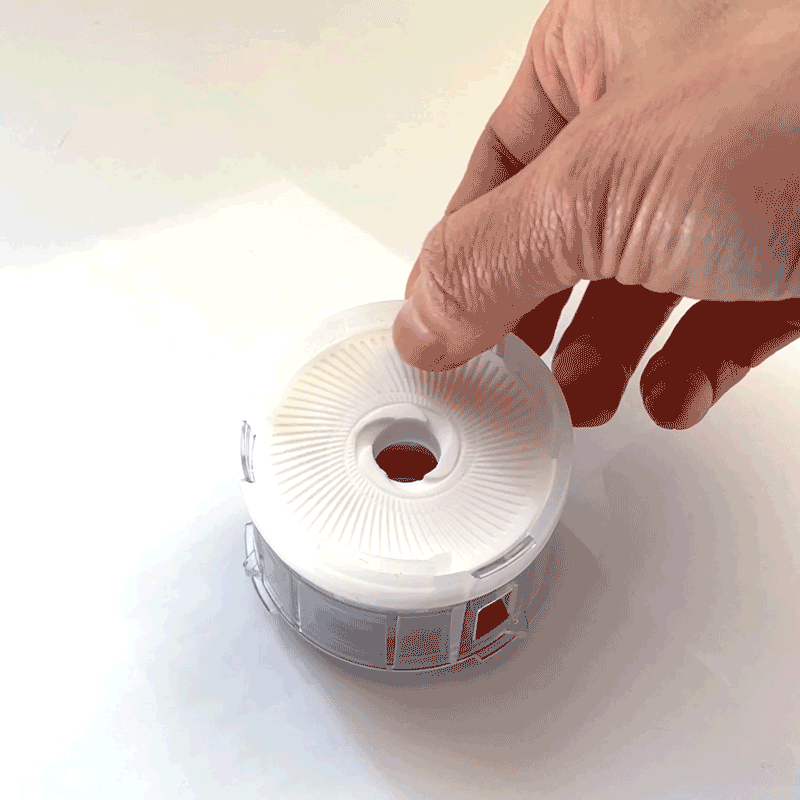 GIF: A person gently pulls the upper spatula off of the Cuzen Matcha Maker's upper mill.