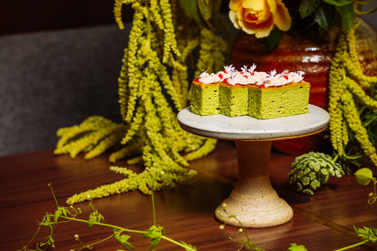 Three fluffy pieces of bright green SingleThread cheesecake, sitting on a cake platter.