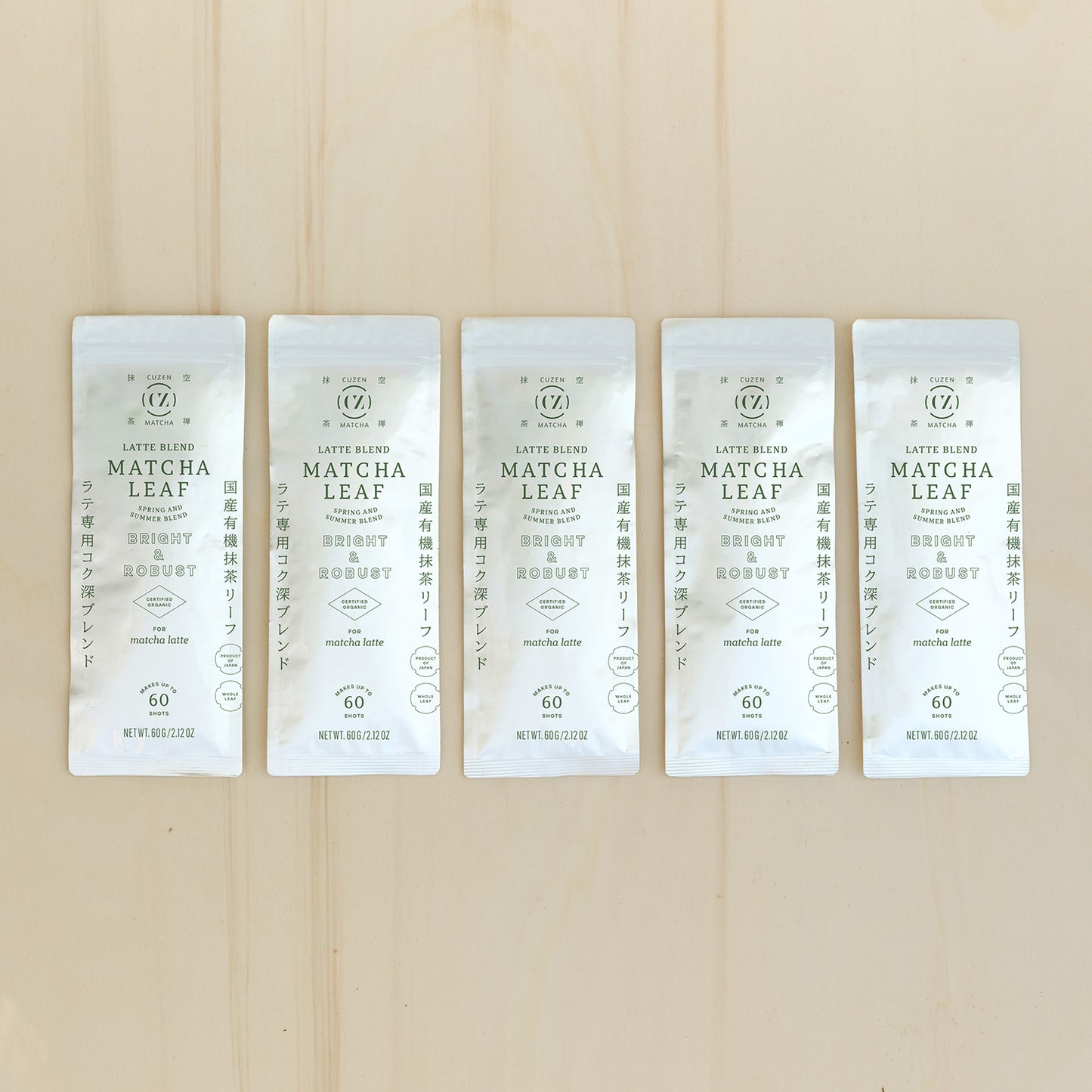 A row of five, white-colored, 60-gram packets of Cuzen’s Latte Blend Matcha Leaf.