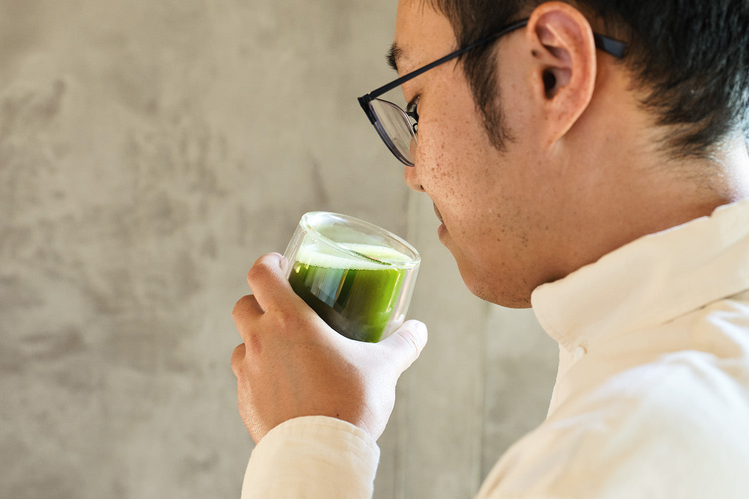 A person enjoys sipping a cup of matcha made from freshly-ground tencha leaves.
