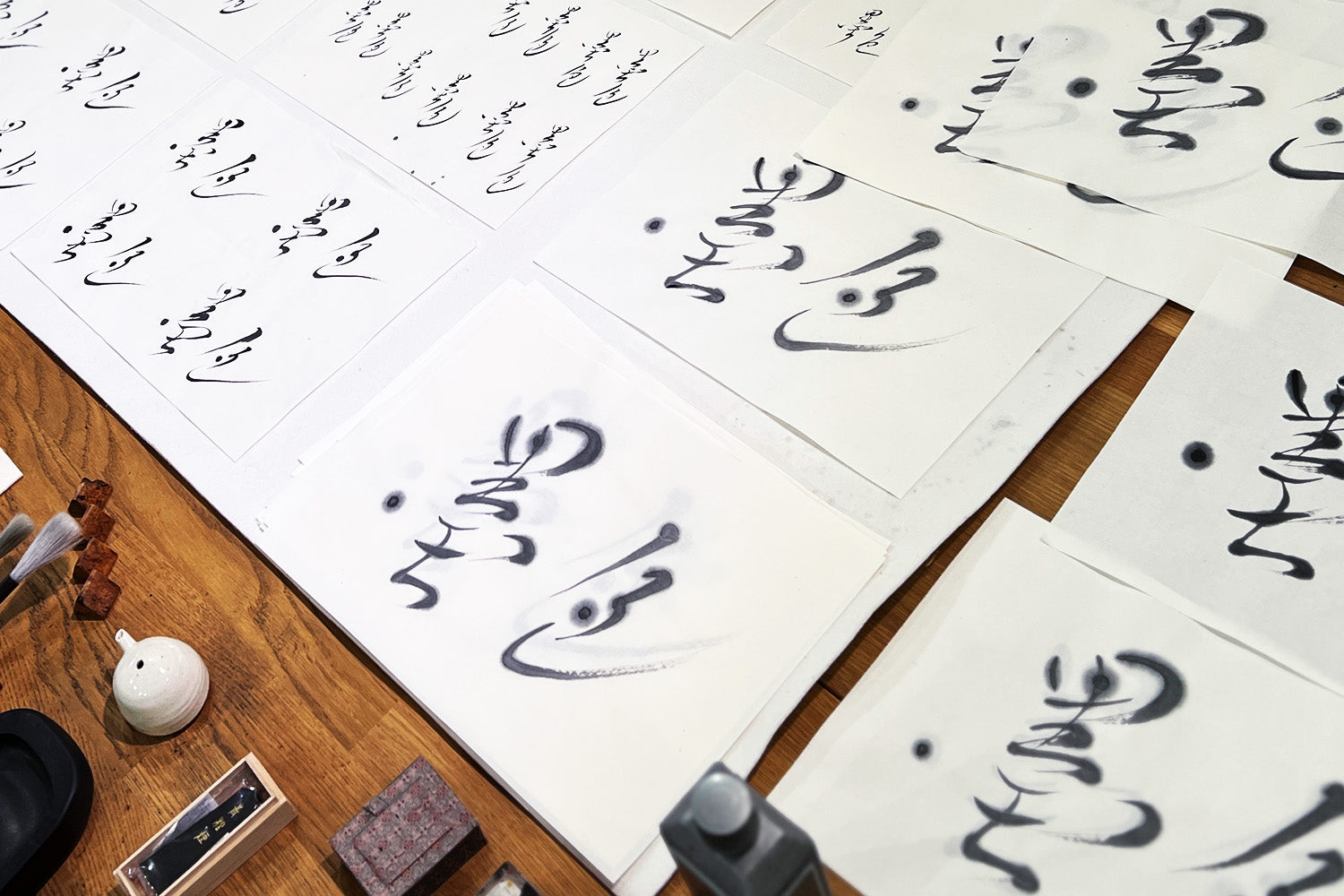 Rows of the words “sumi iro,” or “the color of sumi,” line a worktable in calligrapher Aoi Yamaguchi’s studio.