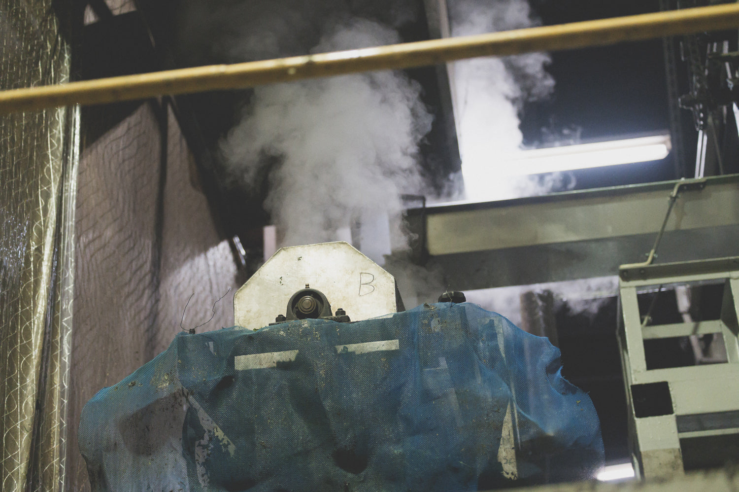 A moist cloud billows out of the machine in which matcha tea leaves are steamed.
