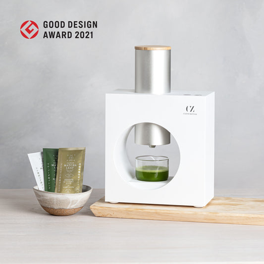 The Matcha Maker, placed next to a small bowl of Cuzen Matcha Leaf packets.