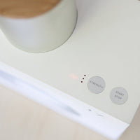 The Matcha Maker’s control panel: the indicator lights, the strength button and the start button.