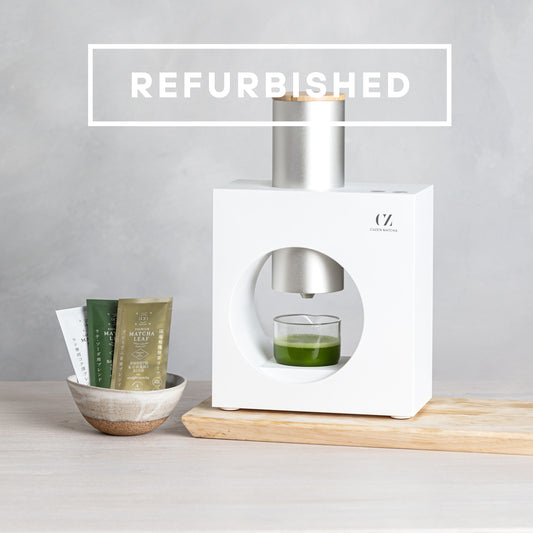 Refurbished Matcha Maker and a bowl of Matcha Leaf sample packets. Overlaid copy reads "REFURIBISHED."