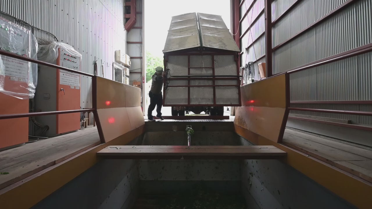 Load video: A worker releases the freshly harvested matcha leaves from the harvesting truck.