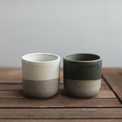  Two artisanal Perfect Matcha Latte cups, one black, one white, set side-by-side.