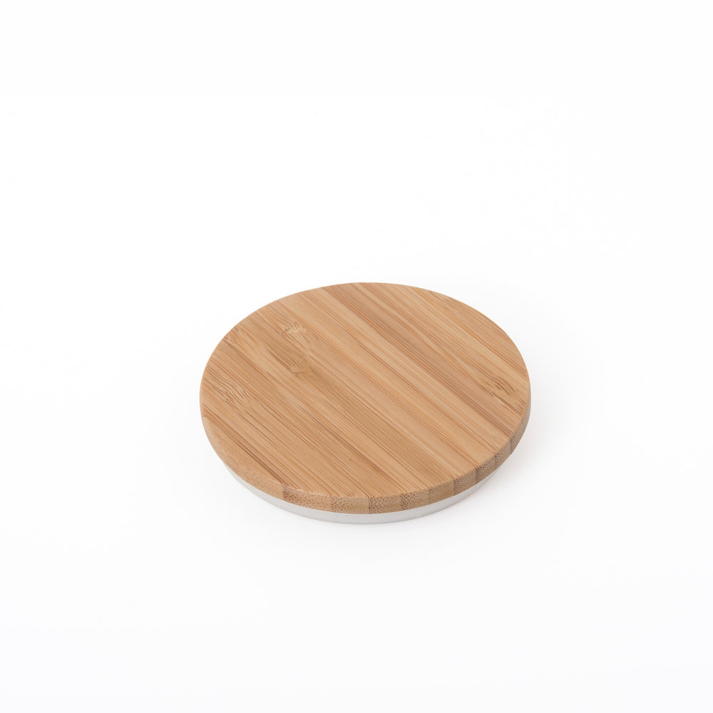 The bamboo lid that covers and seals the tea leaf hopper on the Cuzen Matcha Maker.